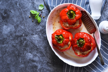 Baked peppers with meat and rice on a concrete background. View from above.