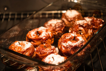 Sweet baked apples in dish in the oven