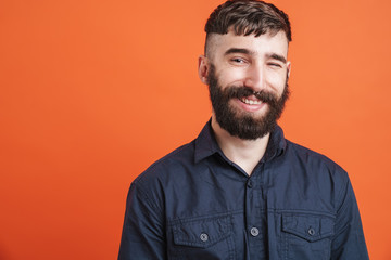 Image of positive stylish man with nose jewelry smiling at camera
