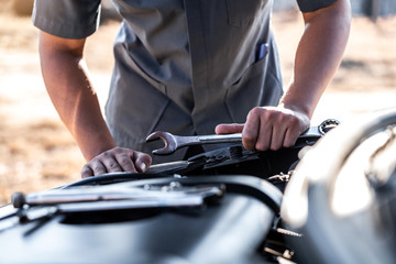 Technician hands of car mechanic in doing auto repair service and maintenance worker repairing vehicle with wrench, Service and Maintenance car check