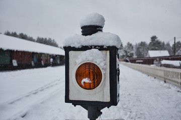 Snow covered old semaphore, orange lamp
