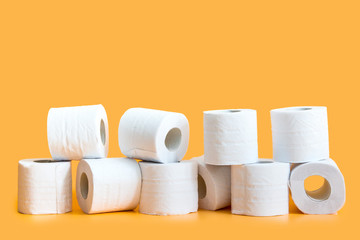 Lots of toilet paper rolls in a groupм