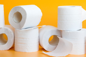 Lots of toilet paper rolls in a groupм