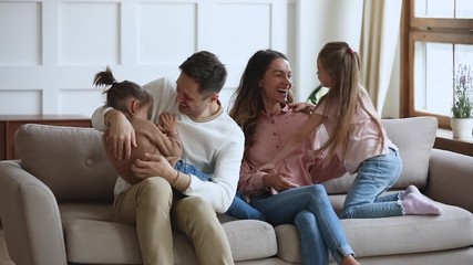 Funny happy family having fun tickling on couch, slow motion - Powered by Adobe