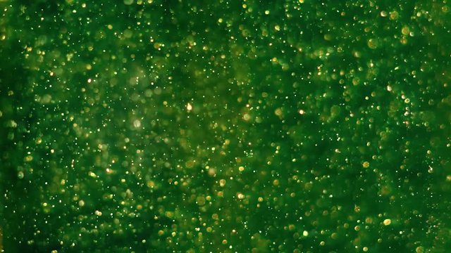 Green substance with bubbles rising