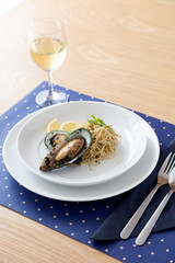 Homemade Mussels pasta meal with white wine on wooden table