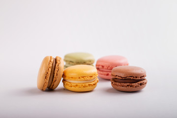 delicious colorful macaroons on gray background