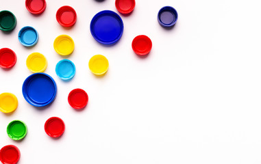 Set of colored plastic covers from bottles isolated on white