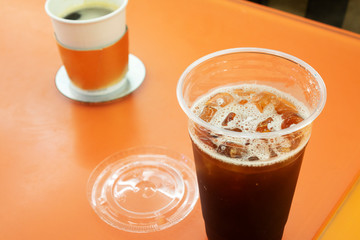 Ice americans coffee in plastic cup on table, close up