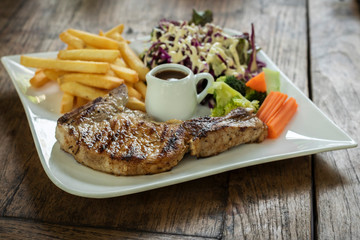 special pork chop steak placed on old wooden table