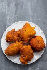 typical portuguese Christmas sweets Sonhos on white dish on ceramic background