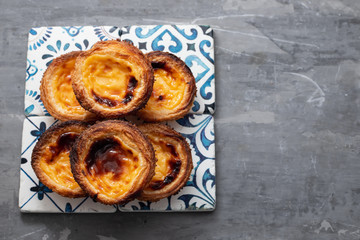 typical portuguese egg tart pastel de nata on ceramic background
