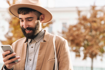 Attractive smiling young man wearing autumn coat