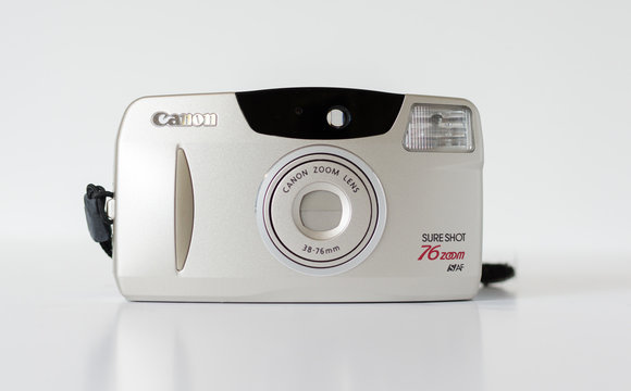 london, england, 05/05/2019  a retro vintage 1990s Canon Sure shot Auto Focus 76 zoom 35 mm film camera isolated on a white background. Canon 4.5 lens, old photographic technology