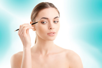 Fototapeta premium Woman applying makeup