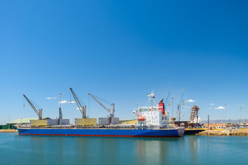 Cargo ship docked in industrial port
