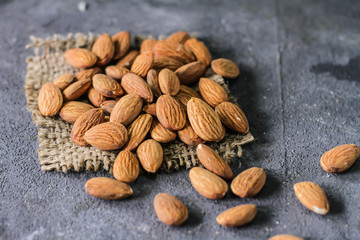 Photo of almond on the table. Almond on dark background. Raw whole almond. Almond concept with copyspace. Images