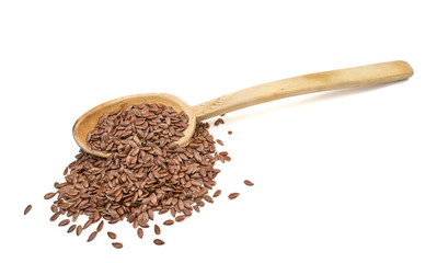 Slanted view of linseeds or flax seeds on a long shafted wooden spoon isolated on white background