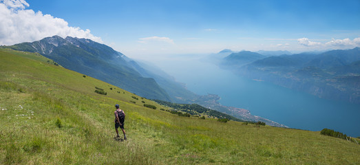 Fototapeta na wymiar mountaineer at Monte Baldo Mountain, hiking trail in summer, view to garda lake