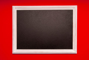 White photo frame with black middle on a red background. Space for text, copy space.