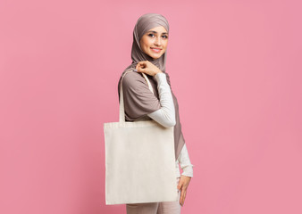 Smiling Arabic Girl With Blank Canvas Eco Bag Over Pink Background