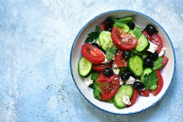 Greek salad from fresh vegetables and feta cheese. Top view with copy space.