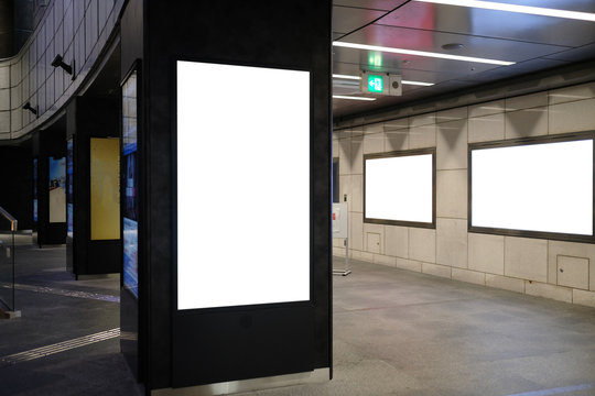 Blank billboard mockup near to escalator in an mall, shopping center, airport terminal, office building or subway station.