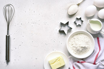 Culinary background with ingredients for baking : egg, flour, butter and milk. Top view with copy space.