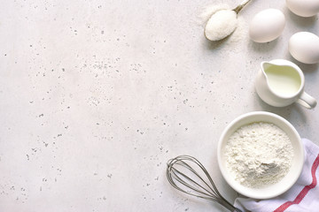 Culinary background with ingredients for baking : egg, flour, butter and milk. Top view with copy space.
