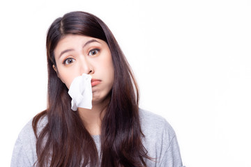 Asian woman have a stuffed nose or runny nose. Pretty girl has a cold or be allergic to weather. It's winter time or rainy season so she hay fever is playing up. She put tissue paper in her nose