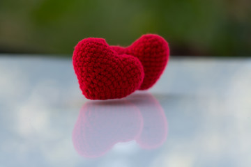Fototapeta premium Beautiful red heart on a natural bokeh background. Valentine's Day .