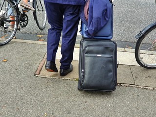 man with suitcase on road