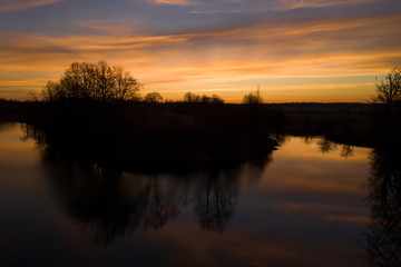 Aerial: Dramatic sunrise above the water