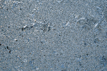Ice and frost on a window pane in winter. Crystal surface of frozen water. Weather forecast: cold, frost, cooling. Abstract blue background or wallpaper. Harsh season