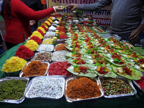Banarasi paan or betel leaf garnished with betel nut and all indian colorful banarasi ingredients for sale