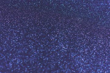 Glowing sparkles on blue color trendy background. Holiday bright brilliant beautiful background, template for blog or designers. Classic Flat lay. New Year 2020