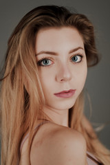 Fototapeta premium portrait of blonde girl with blue eyes and big bokeh
