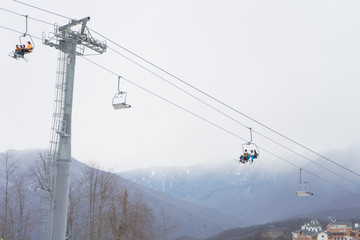 Skiers and snowboarders on a ski lift. Ski resort