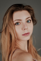 Fototapeta premium portrait of blonde girl with blue eyes and big bokeh