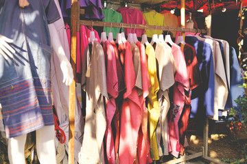 Natural dye clothing of womenswear on hangers in Chiangmai, Thailand.