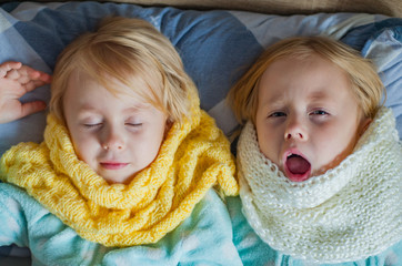 two girls with symptoms of a cold in the bed