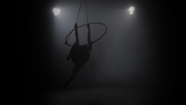 Young girl performs the acrobatic elements in the air ring. Slow motion. 020