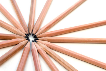 Brown pencils on white background. Creative placement of lots of pencils together in a group.