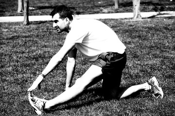 Man at the park doing stretching exercises