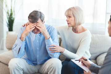 Elderly wife supports her husband during psychotherapy session