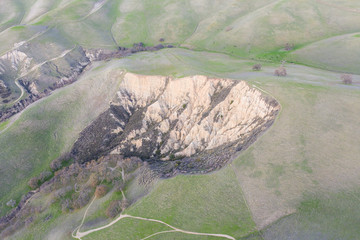 Seen from a bird's eye view, the hills near the Tri-Valley region, just east from Oakland and San Francisco, have turned green after winter rains. Rains can also cause erosion and mud slides.
