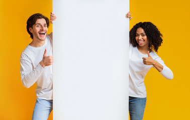 Happy Interracial Couple Holding White Advertising Board And Showing Thumbs Up