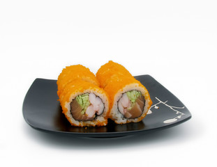 California rolls on a black plate on a white background
