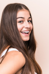 Young cute caucasian woman against a beige background © Asier