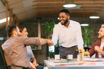 CEO handshaking with employee, congratulating with professional achievement